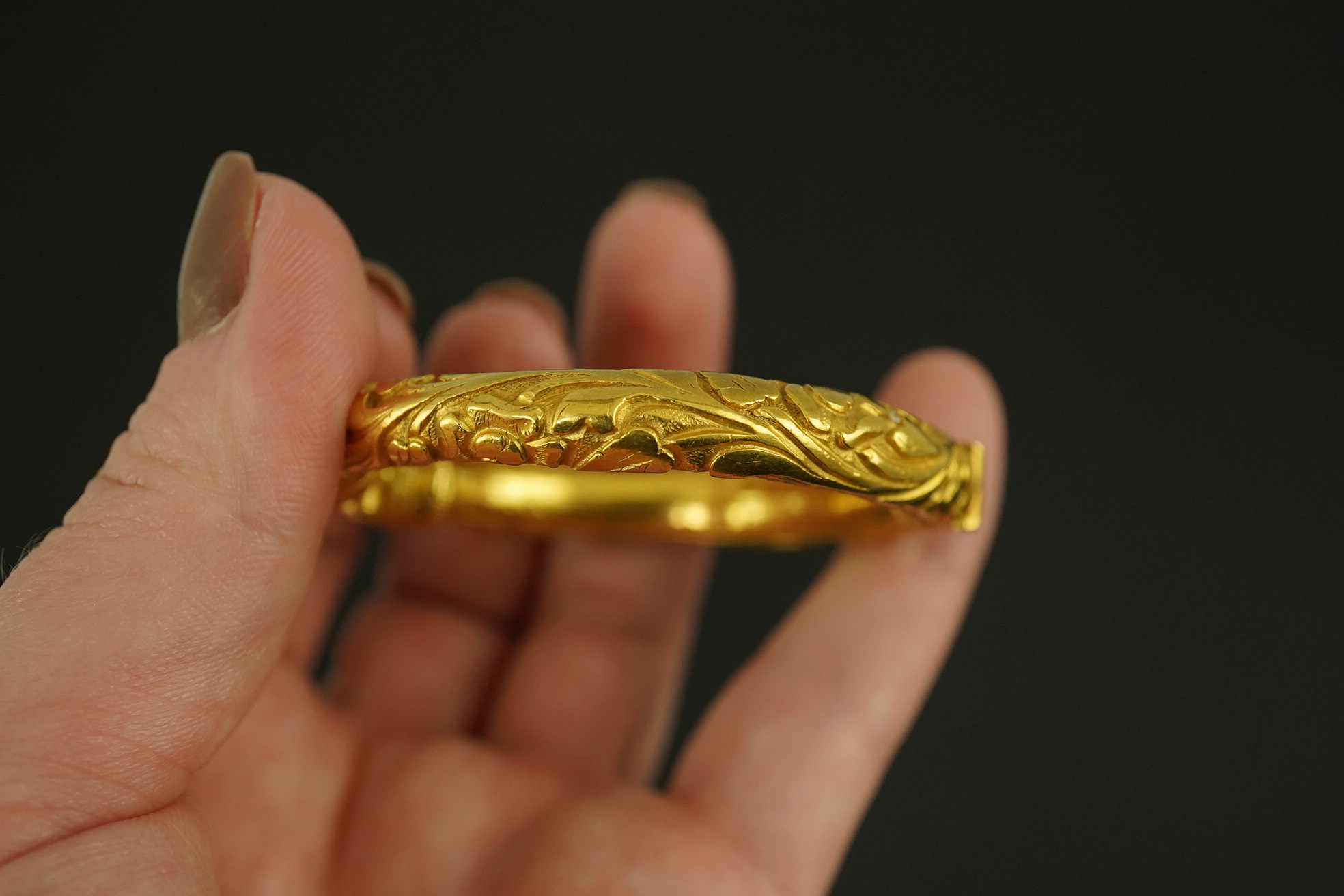 An antique Indian? high carat gold hinged bangle